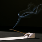 Incense stick with smoke on a black background
